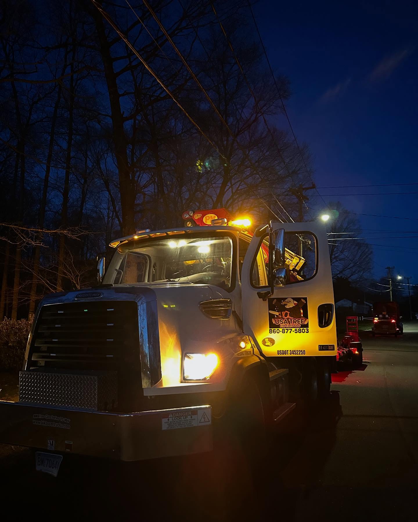 USA Tree Experts emergency response truck with lights on during nighttime tree service in Wethersfield, CT