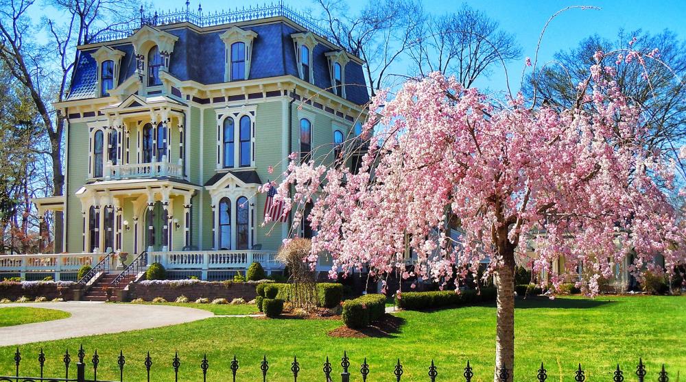 Historic Victorian home with blooming cherry blossoms in Wethersfield, CT during spring